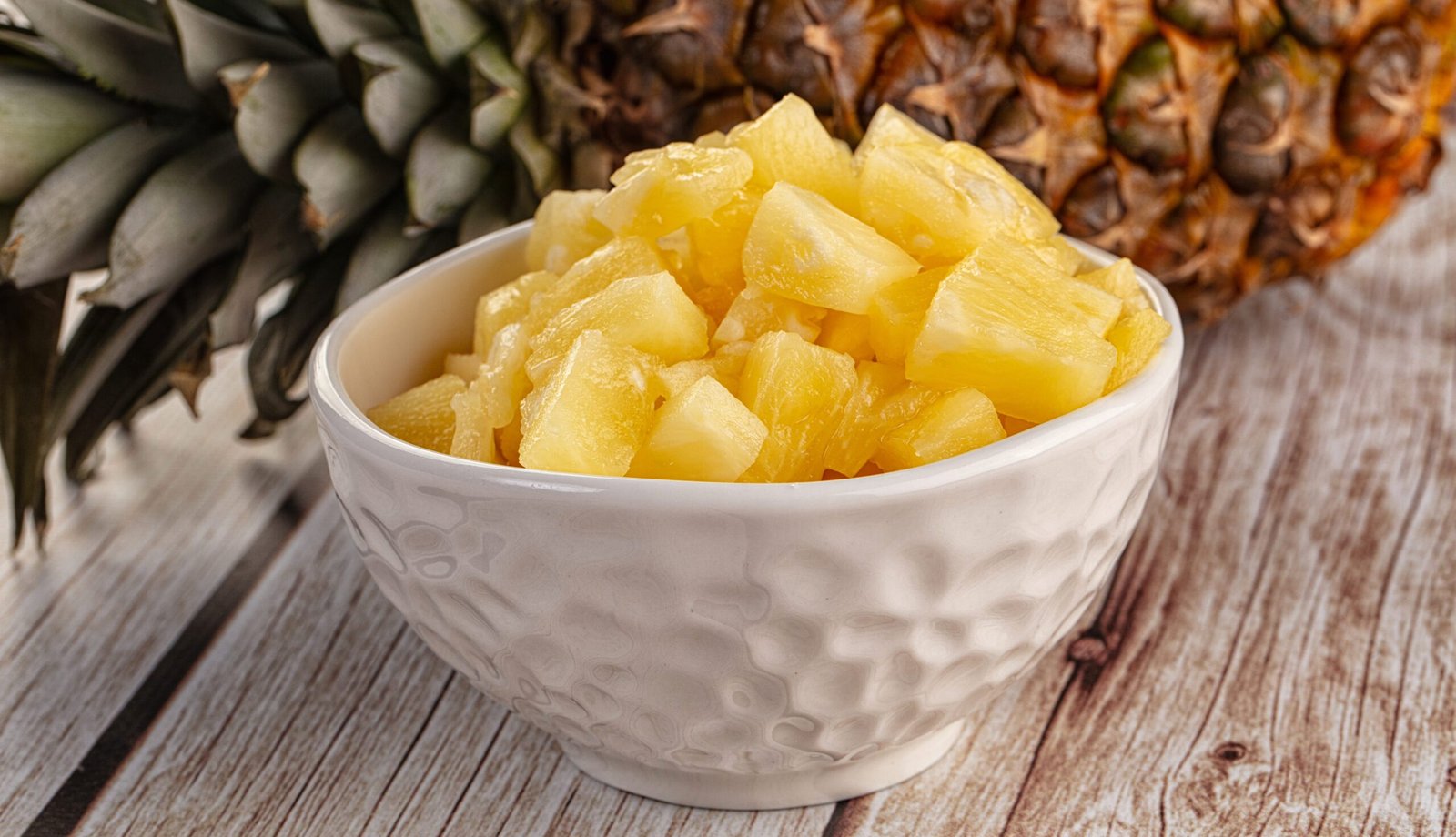 Sweet canned pineapple fruit pieces with syrope