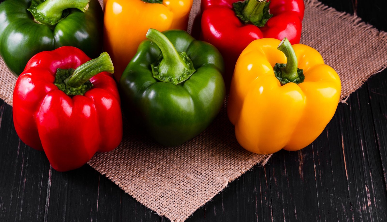 Three sweet peppers on a wooden background, Cooking vegetable salad